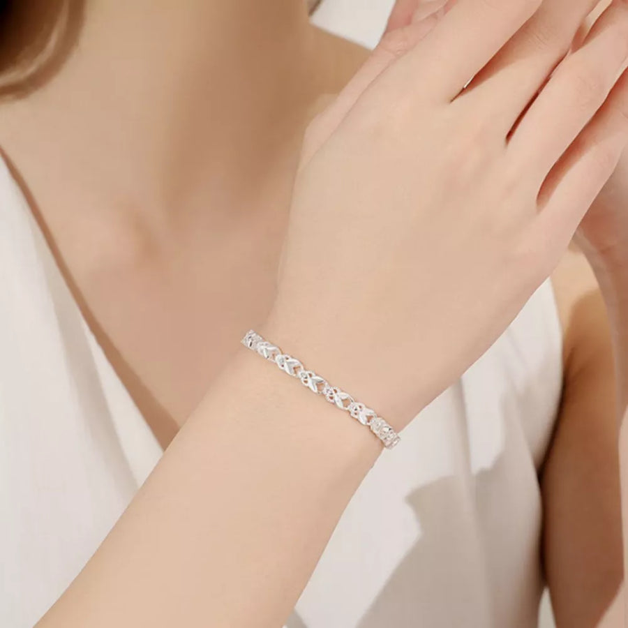 Silver bracelet featuring interlocking links and geometric