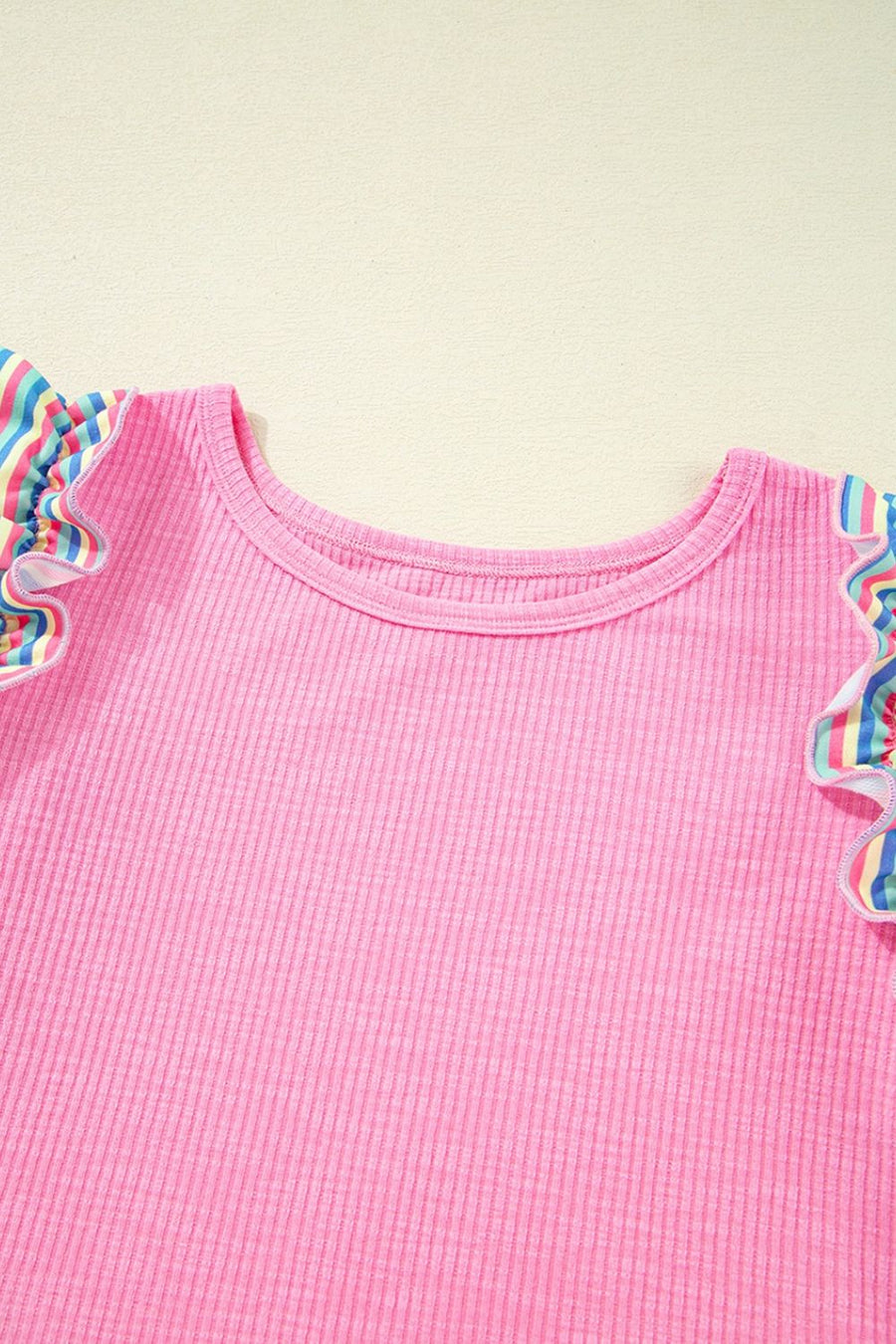 Pink ribbed knit top with pastel stripe ruffle sleeves