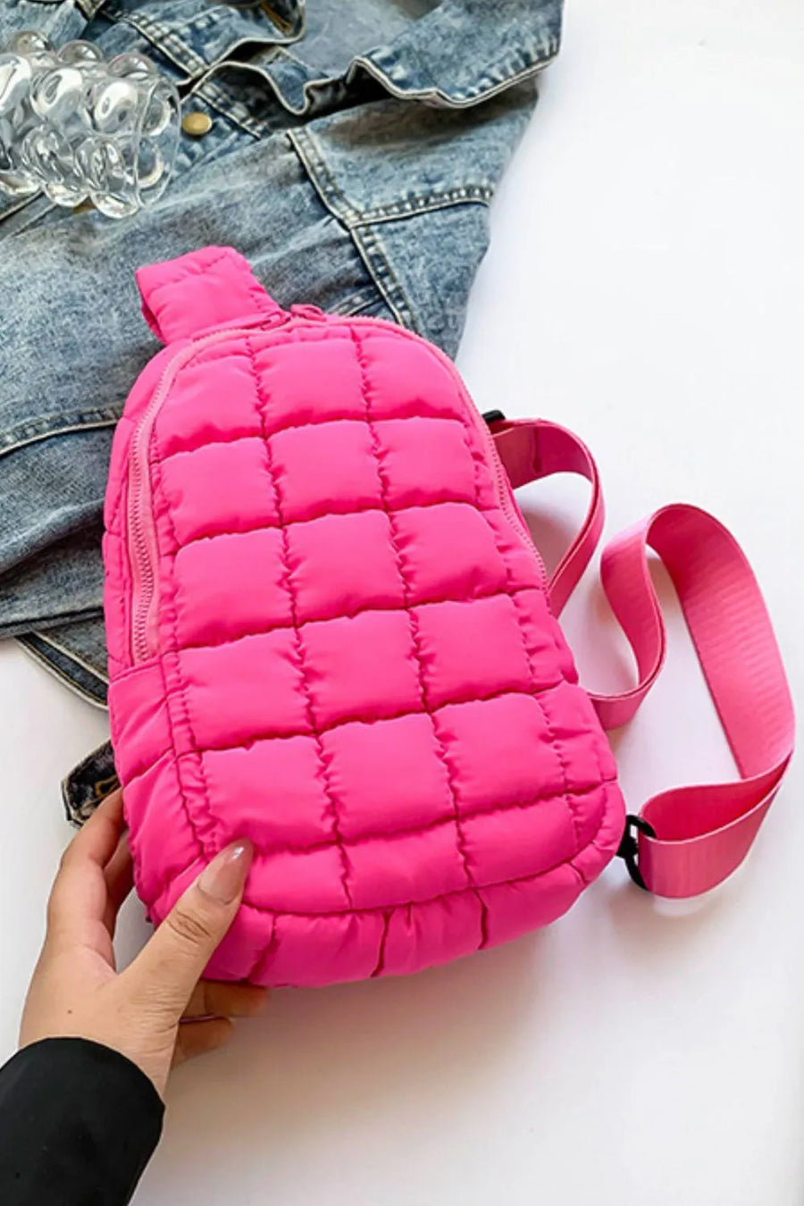 Padded sling bag in hot pink with quilted pattern and top handle