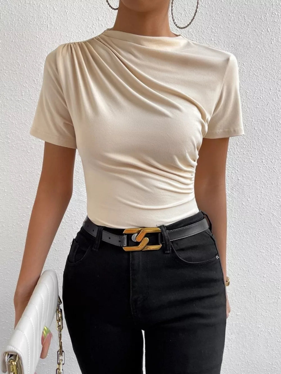 Apricot ruched mock neck t-shirt with draped detailing and short sleeves.