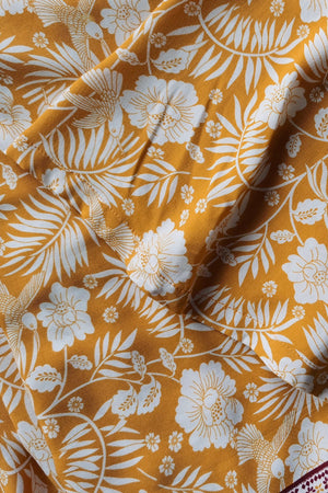 Bohemian floral print crop top and maxi skirt set in tangerine viscose with white flowers and birds.
