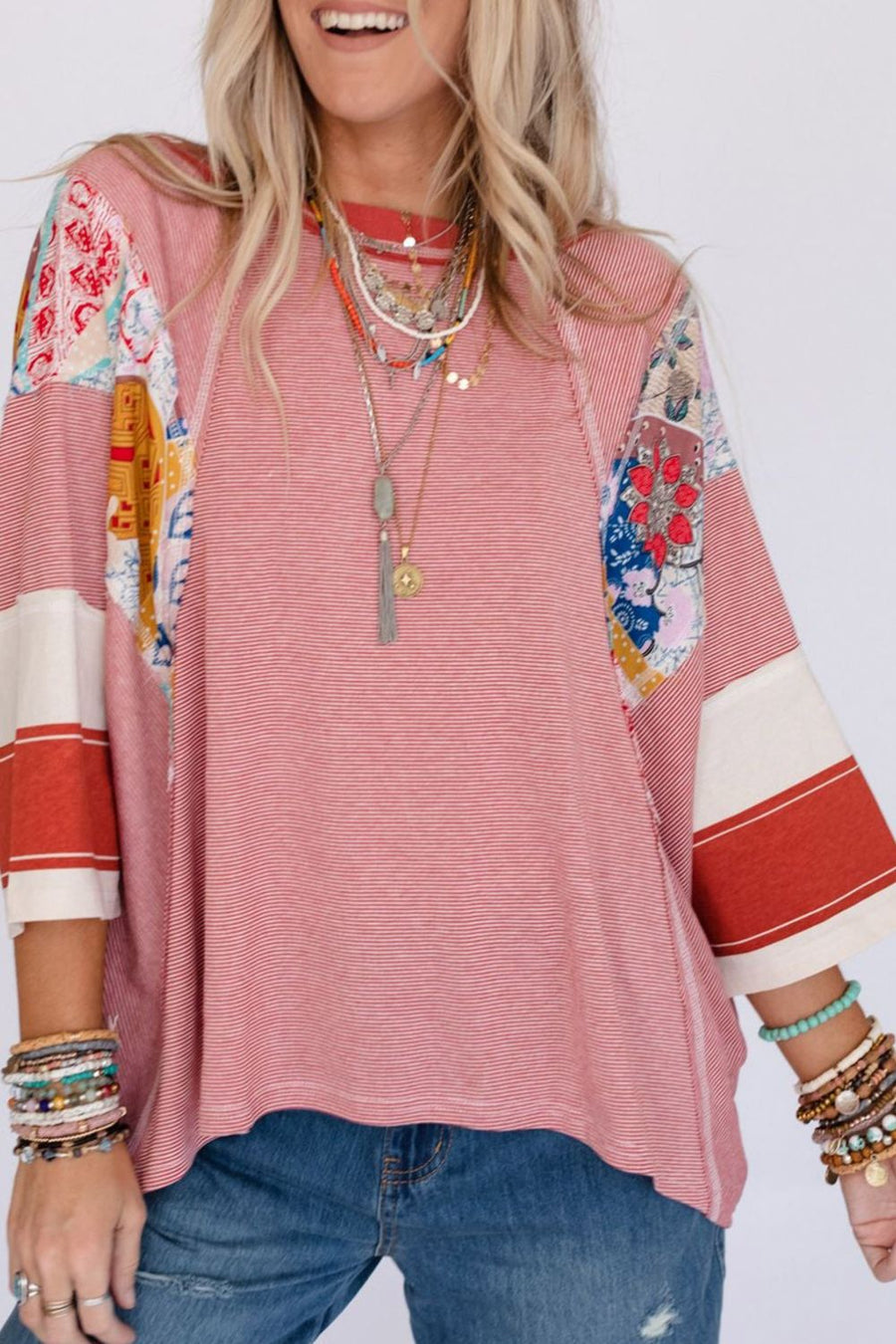 Patchwork stripe raglan tee in deep red with colorful boho sleeve panels and striped cuffs.