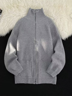 Grey ribbed zip-up sweater with high neck and pockets