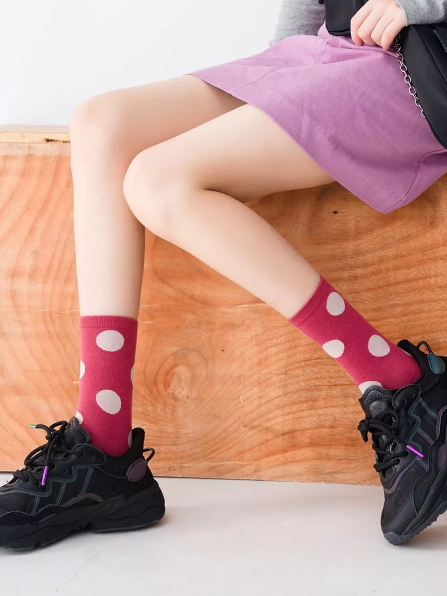 white socks featuring elastic cuff and polka dot
