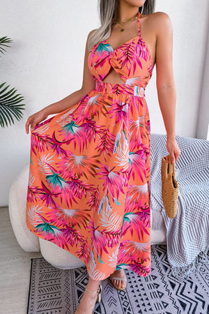 Orange tropical halter maxi dress with cutout detail and botanical print.