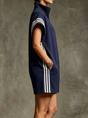 Navy blue sporty zip-up romper with white stripes on sleeves and sides, and pockets.