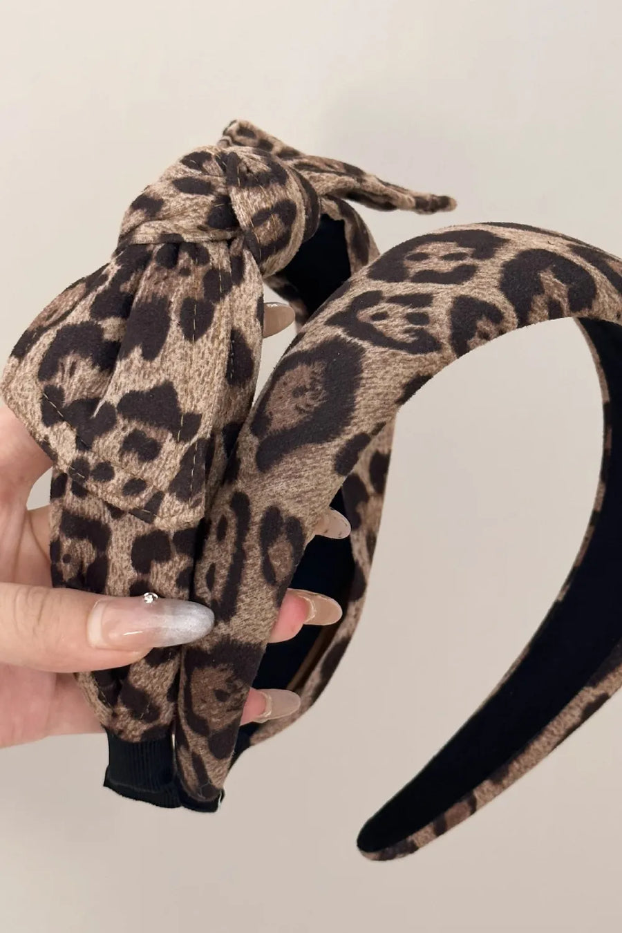 Leopard print knotted headband with a bold design.