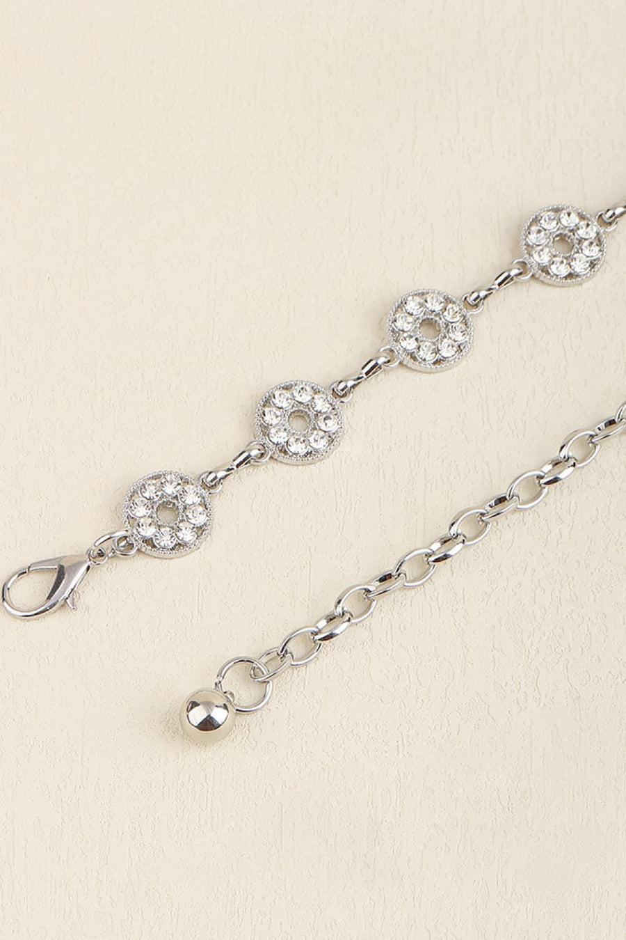 Silver chainmail belt with circular rhinestone accents and a lobster clasp closure.
