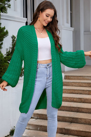 Mid green textured knit cocoon cardigan with balloon sleeves and open front.