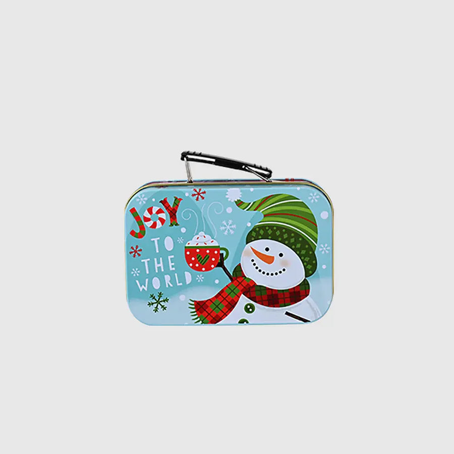 Festive illustrated suitcase tin box with snowman and hot cocoa, perfect for Christmas gifts.