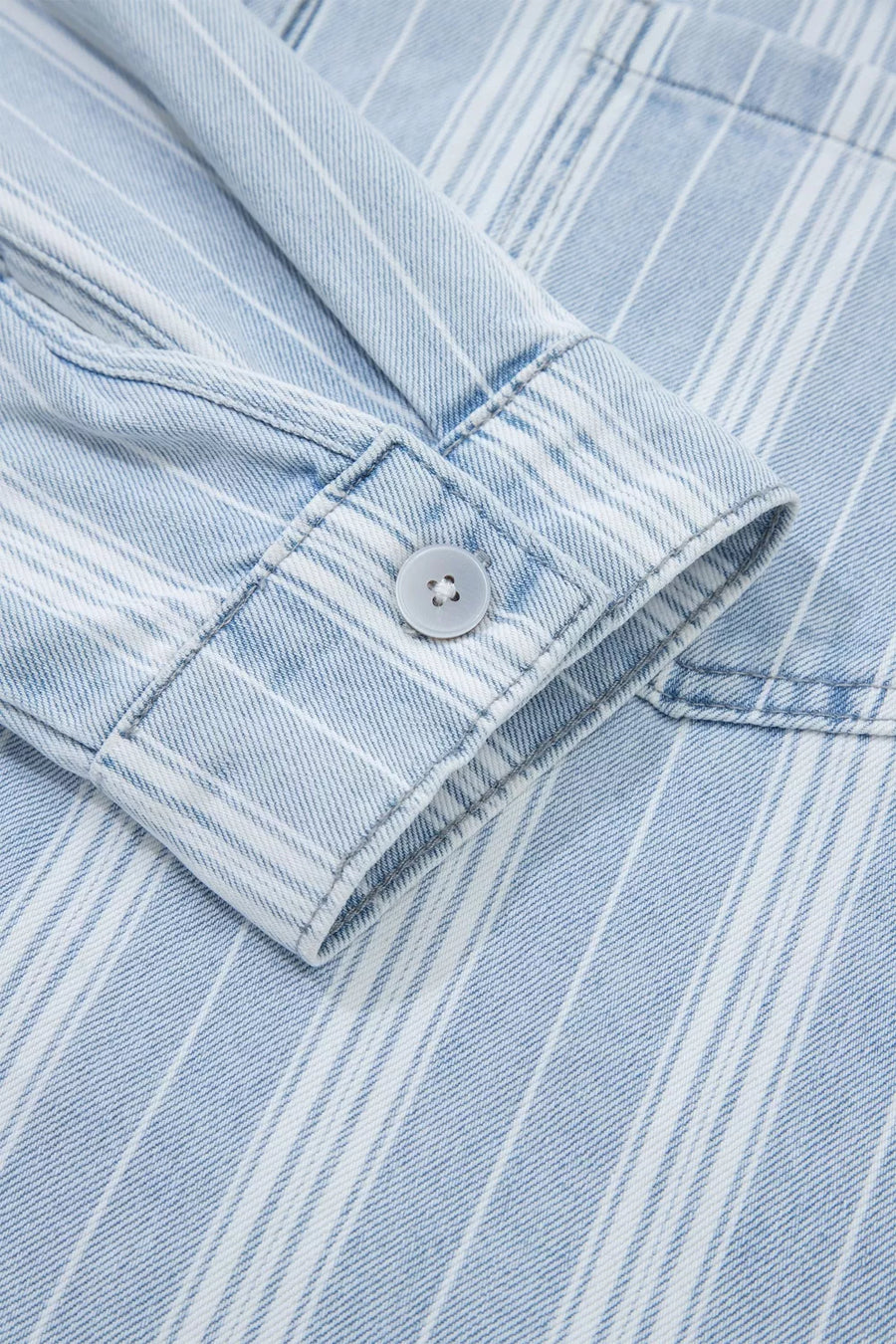 Denim shacket with white vertical stripes, button cuff detail, and chest pocket.