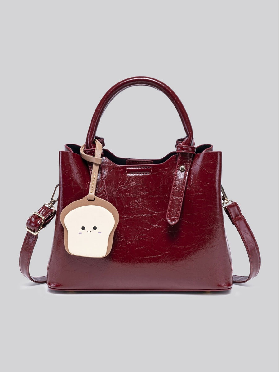 handbag in burgundy with top handle and medium