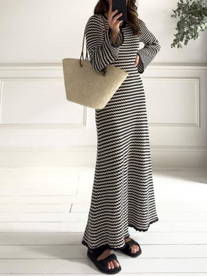 Black and white striped maxi sweater dress with bell sleeves and a flared hem.