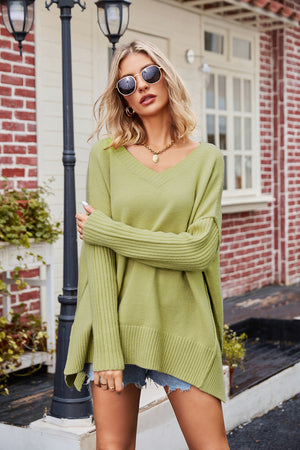Lime v-neck acrylic sweater with asymmetric hem and ribbed sleeves.