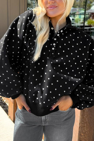 white sweatshirt featuring buttoned and polka dot