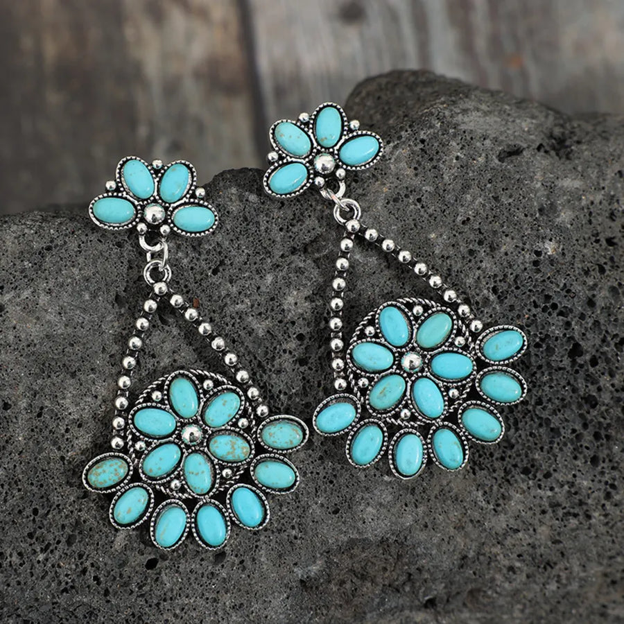 Silver Southwestern turquoise floral dangle earrings with alloy metal.