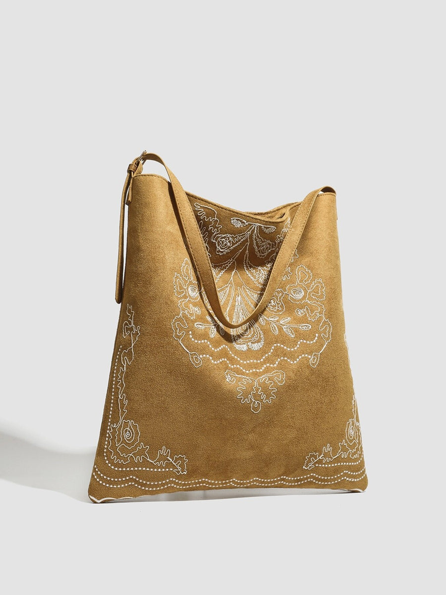 Brown handbag featuring embroidered and embroidered