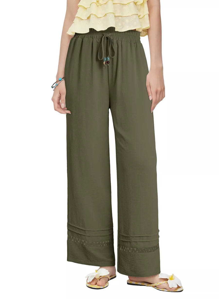 Relaxed wide-leg maternity pants in Matcha Green with drawstring and embroidered hem detail.