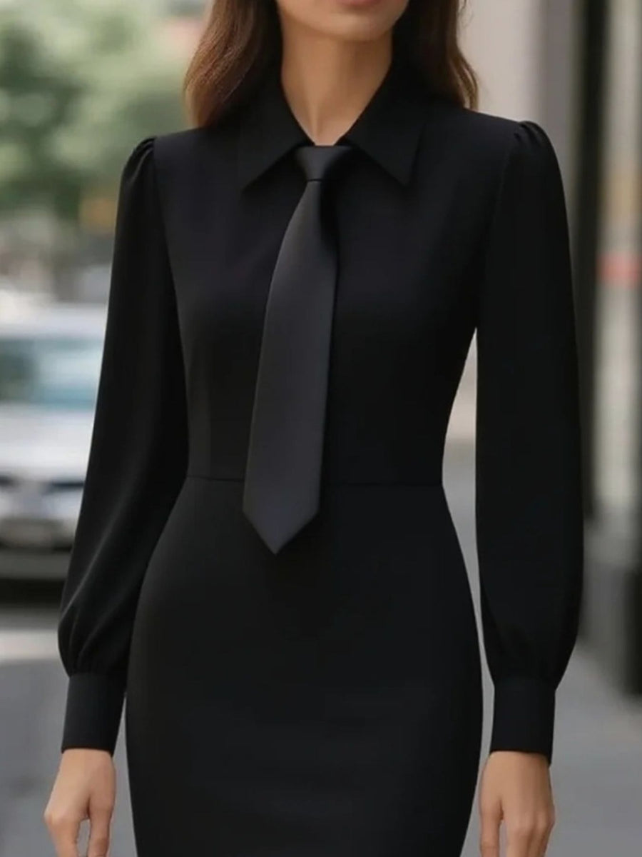 Black tie-neck long sleeve dress with buttoned collar and puff sleeves.