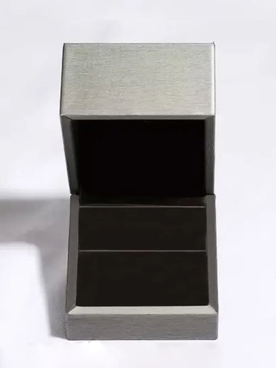 Open jewelry box with grey exterior and dark interior.