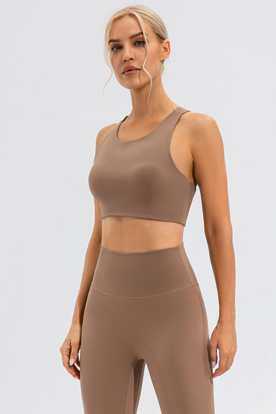 Camel sports bra with asymmetric cutout detail and racerback.