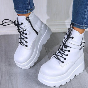 White platform buckle lace-up booties with side zipper and black laces.