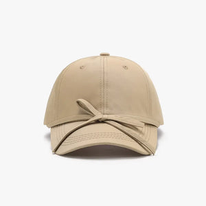 Tan baseball cap with a tied ribbon detail on the brim