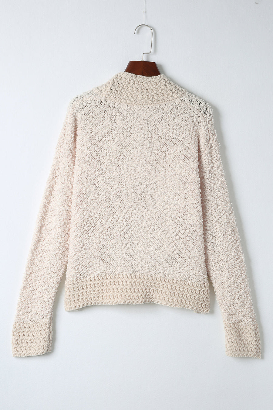 Cream textured bouclé open-front jacket with long sleeves and ribbed cuffs.