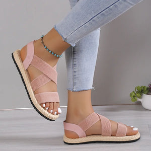 Dusty pink crisscross elastic summer sandals with woven sole detail.