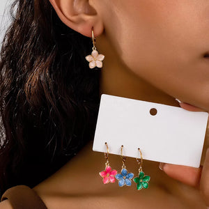 light blue earrings featuring flower charm and floral