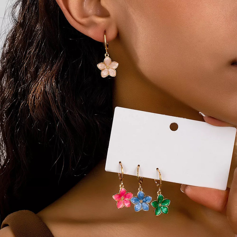 light blue earrings featuring flower charm and floral