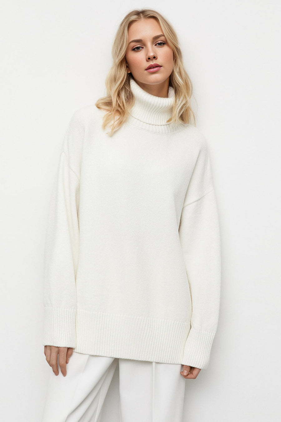 Oversized white turtleneck sweater with ribbed cuffs and hem, relaxed fit.