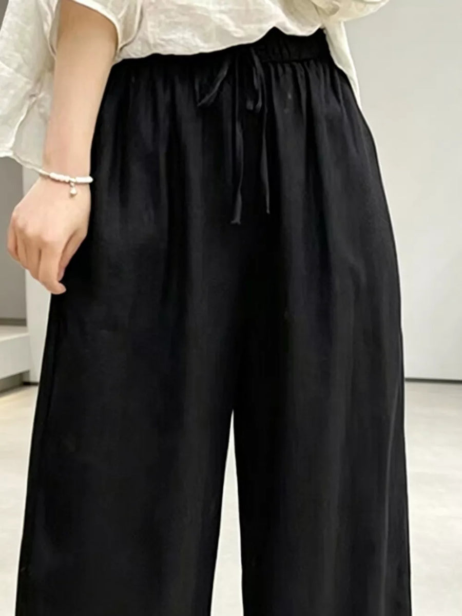 Black maternity pants with drawstring waist and pockets, ankle length.