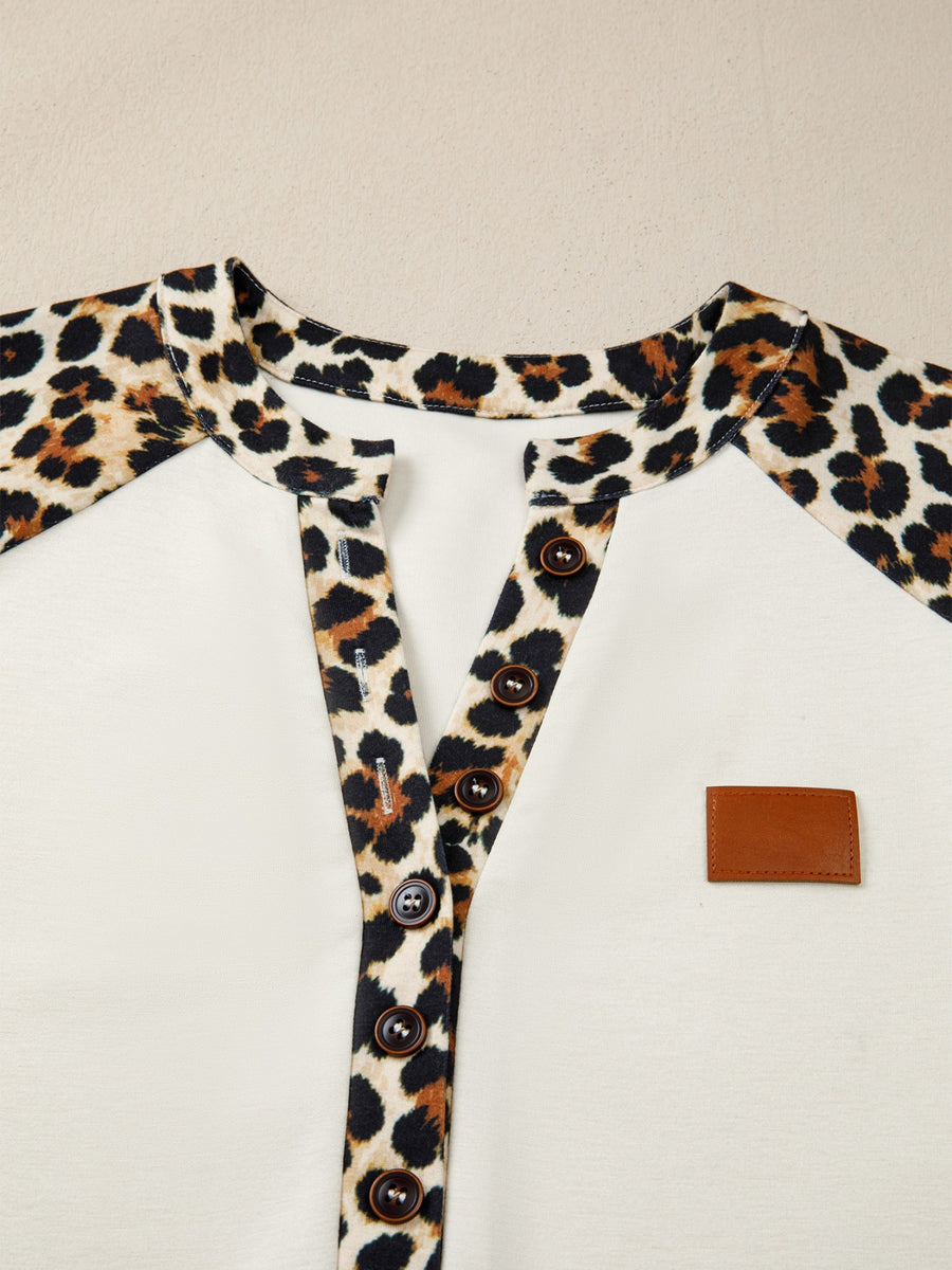Buttoned blouse with leopard print collar and placket, beige body, and brown buttons.
