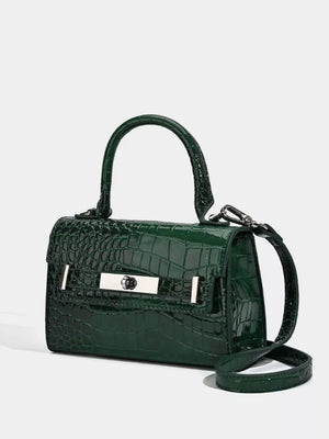 Green croc-embossed small tote bag with silver hardware and adjustable strap.