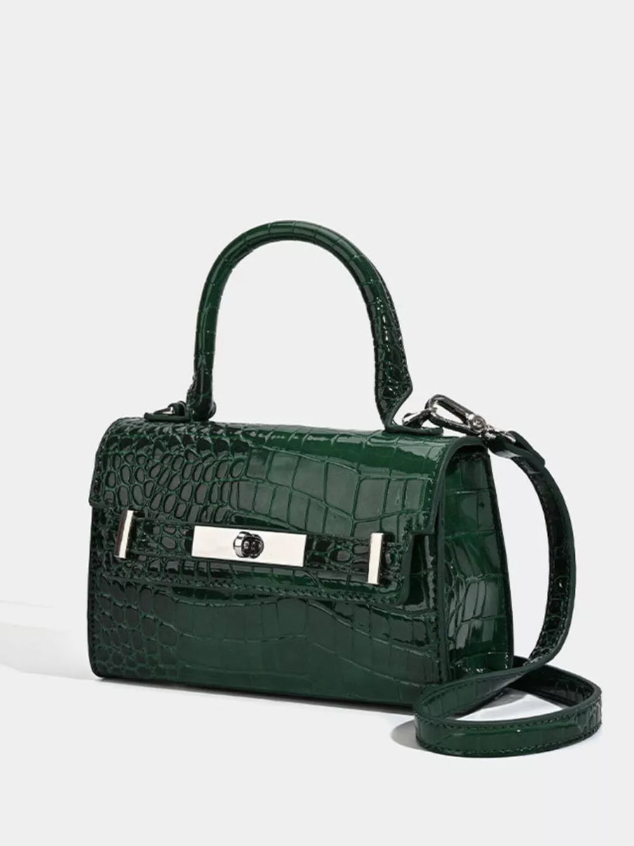 Green croc-embossed small tote bag with silver hardware and adjustable strap.