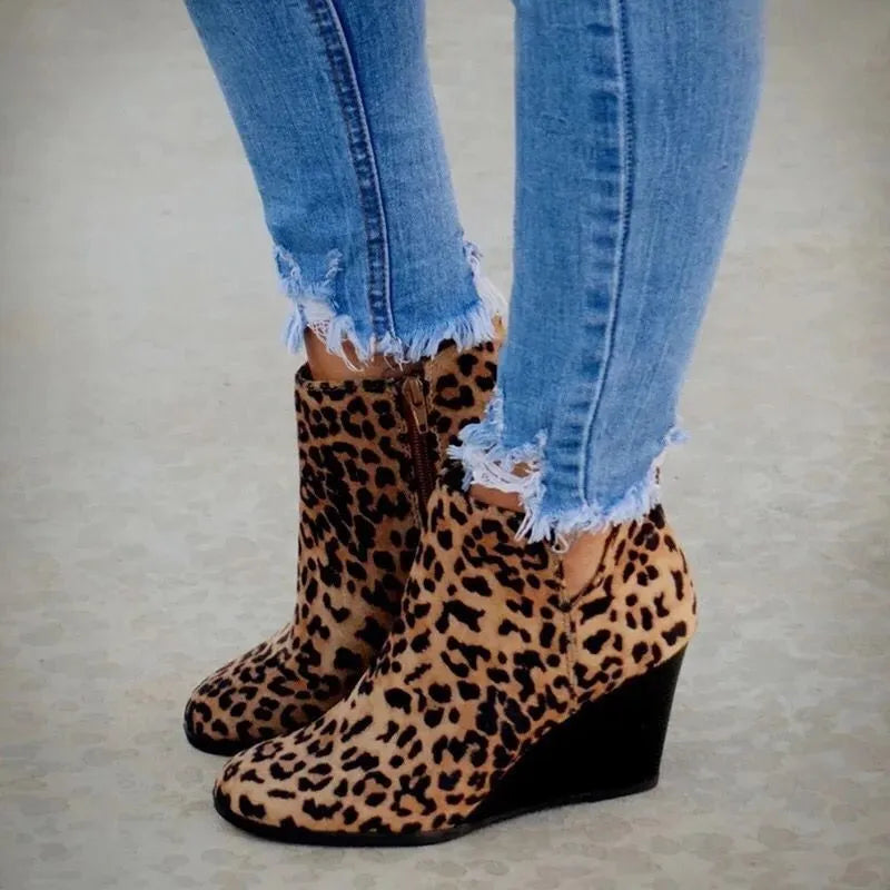 Leopard print wedge ankle boots with side zipper and distressed jeans.