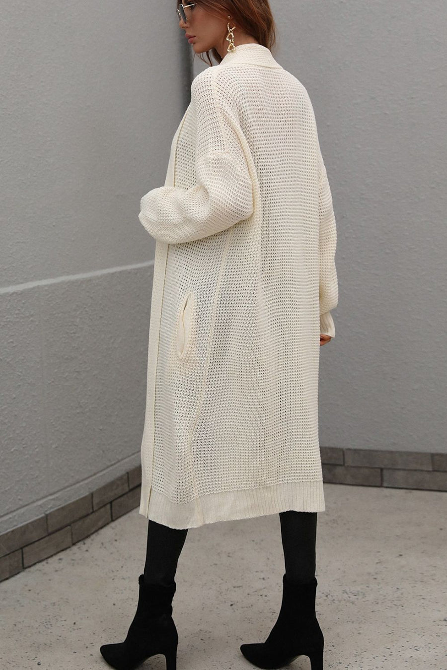Cream textured knit maxi cardigan with pockets and a relaxed fit.