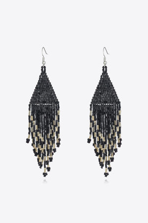 Black and gold beaded fringe earrings with a triangular shape and cascading strands.