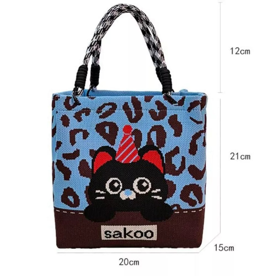 Cartoon graphic tote handbag in blue with leopard print and black cat design.