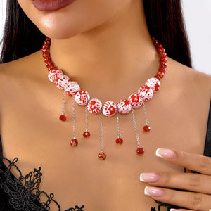 red necklace with splatter and n/a