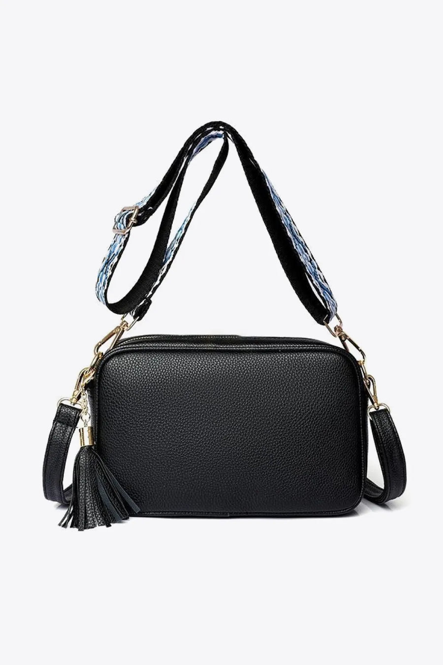 Black textured crossbody bag with tassel detail and patterned strap