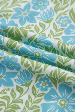 Floral ruffled half sleeve maternity blouse in blue and green floral print on white.