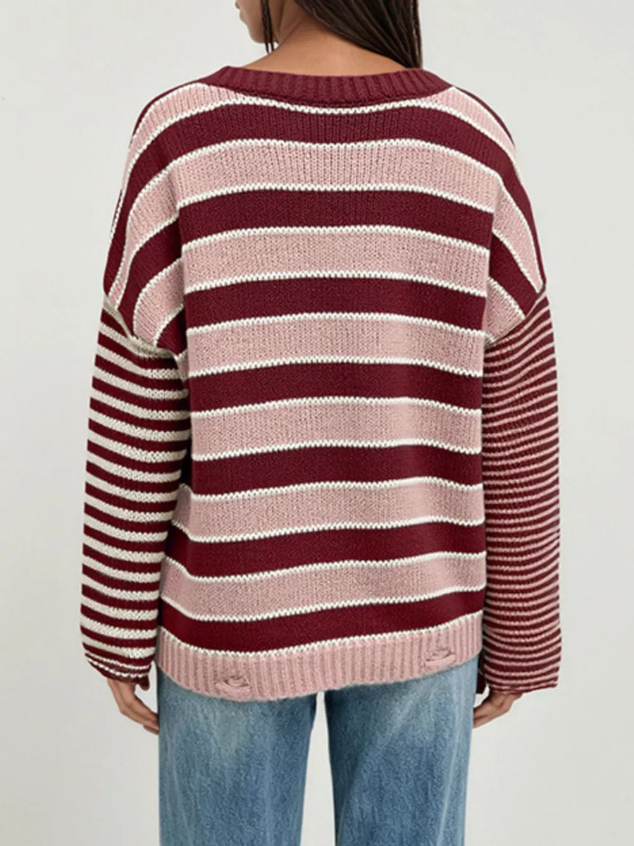 blush pink pullover sweater featuring distressed and striped