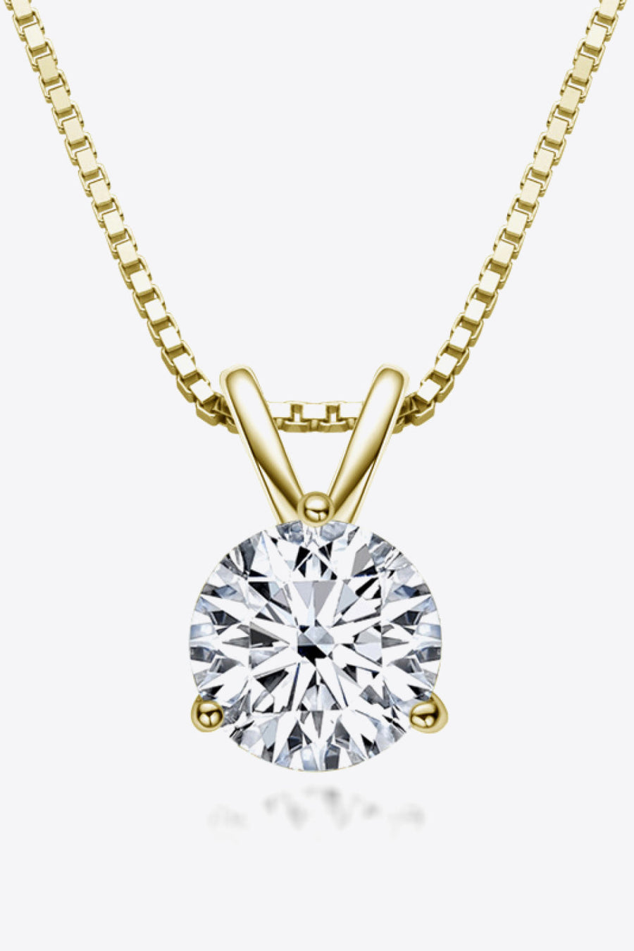 Gold box chain necklace with a round brilliant cut solitaire moissanite pendant.
