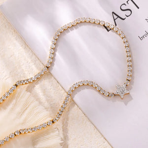 Gold choker necklace with pavé starburst detail and clear crystals