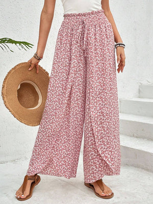 Floral print wrap-front palazzo pants in blush pink with a drawstring waist and wide leg.