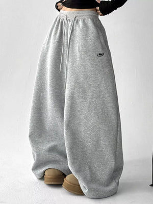 wide-leg pants in light grey featuring drawstring waist and loose fit