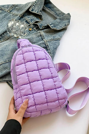 Padded sling bag in pastel blue with quilted pattern and top handle