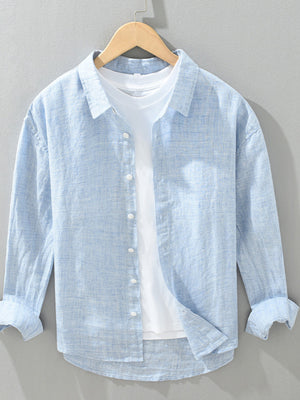 button-up shirt in light blue featuring button cuffs and regular fit